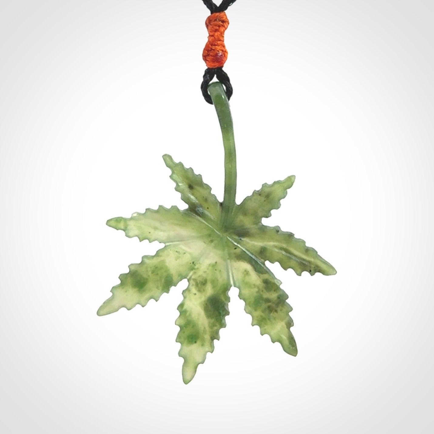 Cannabis Leaf Jade Stone pendant. Handmade jade Cannabis flower jewellery made by NZ Pacific and for sale online. Jade stone Marijuana leaf pendant for men and women. Unique art to wear from NZ Pacific. Delivered on an adjustable cord.