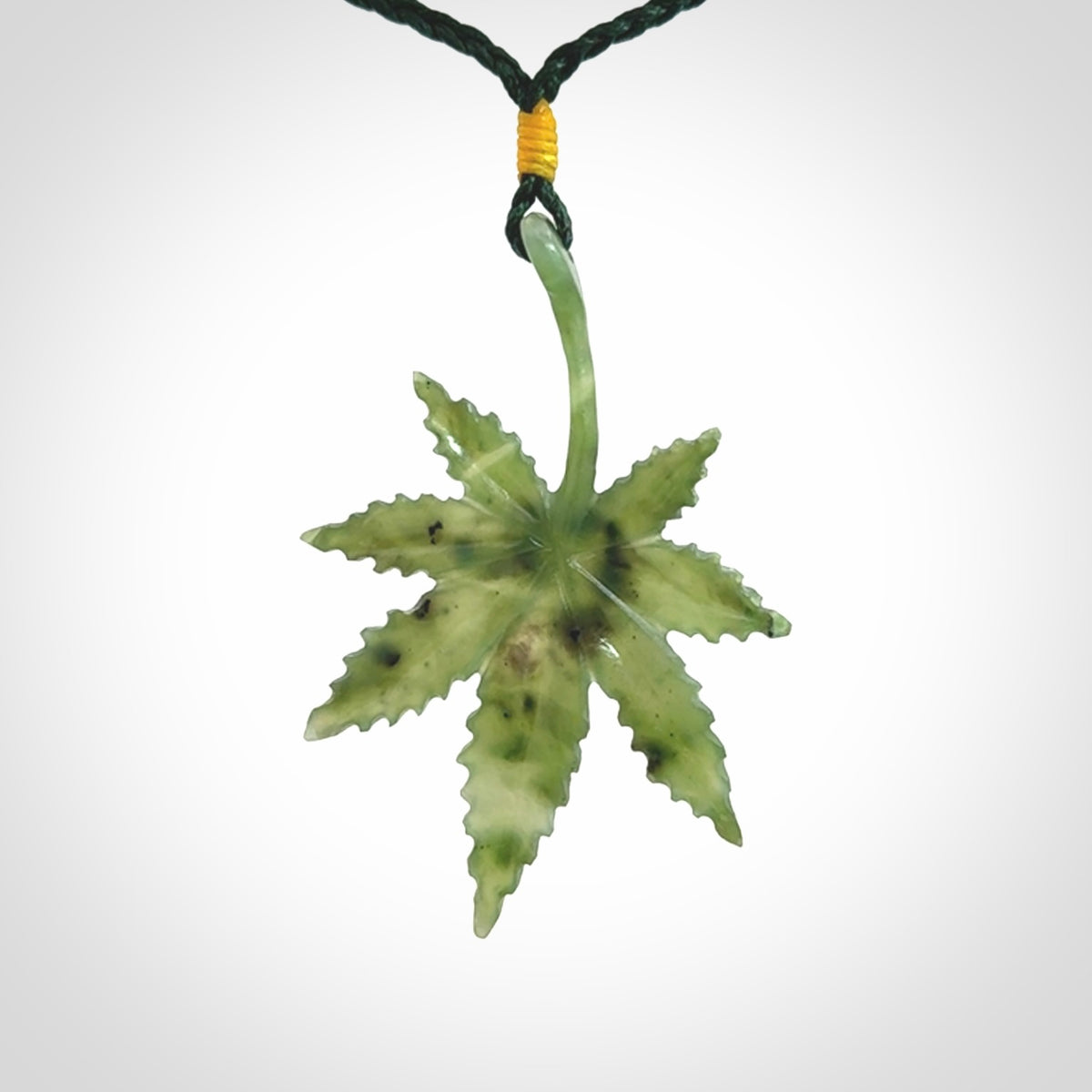 Cannabis Leaf Jade Stone pendant. Handmade jade Cannabis flower jewellery made by NZ Pacific and for sale online. Jade stone Marijuana leaf pendant for men and women. Unique art to wear from NZ Pacific. Delivered on an adjustable cord.