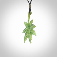Cannabis Leaf Jade Stone pendant. Handmade jade Cannabis flower jewellery made by NZ Pacific and for sale online. Jade stone Marijuana leaf pendant for men and women. Unique art to wear from NZ Pacific. Delivered on an adjustable black cord.
