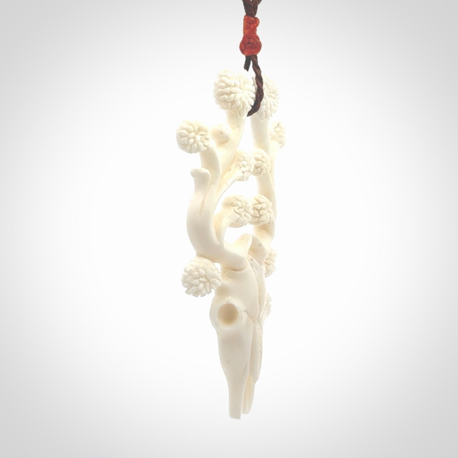 This is a hand carved contemporary bison bone skull pendant. This is a medium sized necklace and is a very unique pendant that is a piece for bison lovers.