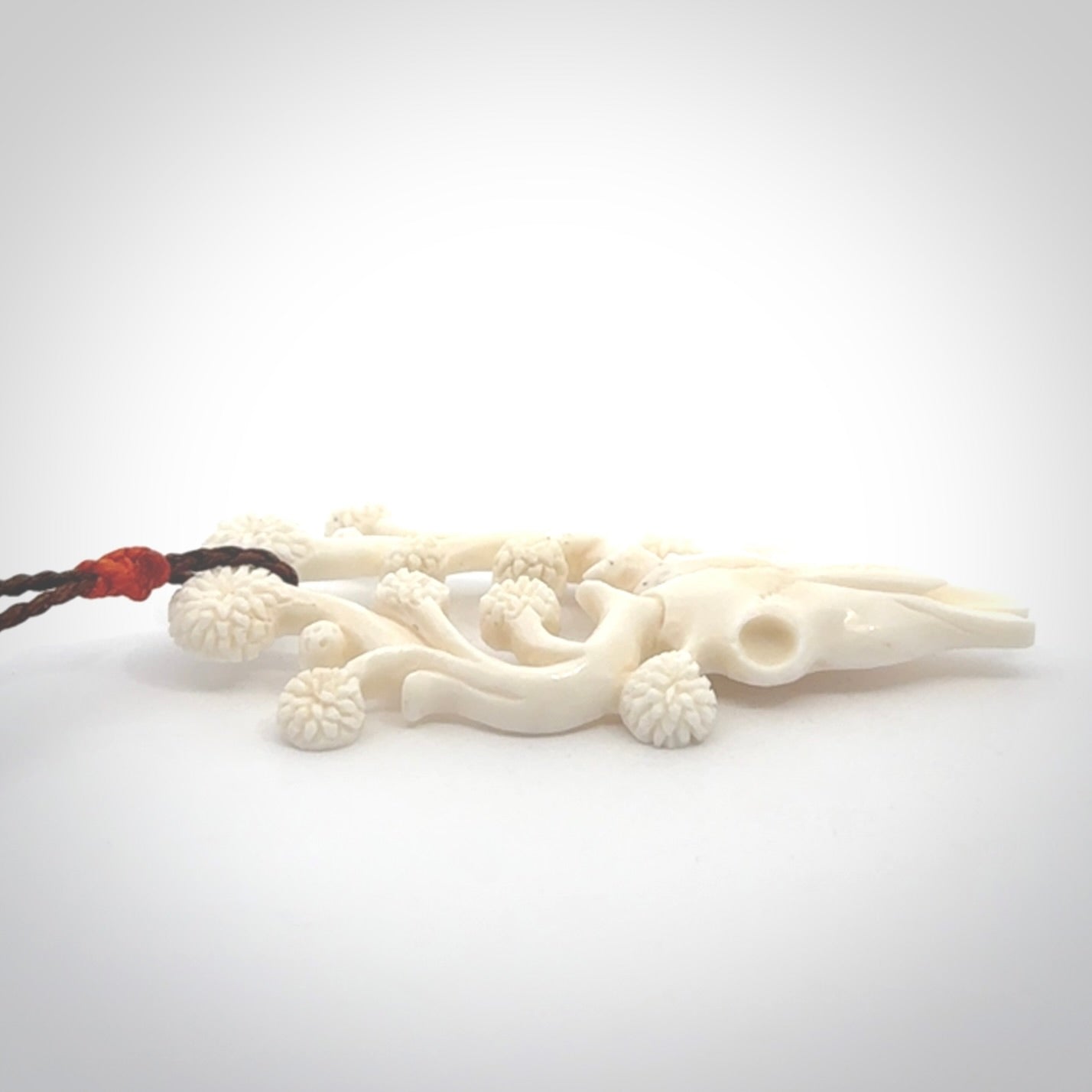 This is a hand carved contemporary bison bone skull pendant. This is a medium sized necklace and is a very unique pendant that is a piece for bison lovers.