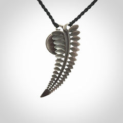 This is a hand carved Sterling Silver Fern leaf pendant with New Zealand flower Jade insert. This is a medium sized necklace and is provided with an adjustable black cord.