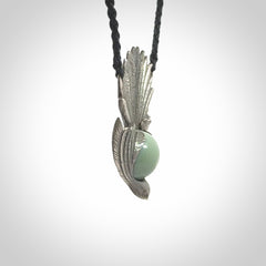 This is a hand carved Sterling Silver Fern fantail pendant with New Zealand Jade insert. This is a medium sized necklace and is provided with an adjustable black cord.