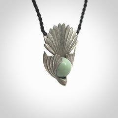 This is a hand carved Sterling Silver Fern fantail pendant with New Zealand Jade insert. This is a medium sized necklace and is provided with an adjustable black cord.