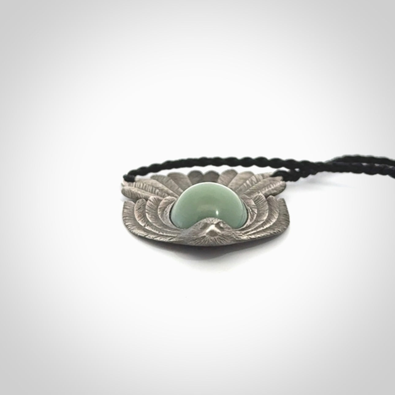This is a hand carved Sterling Silver Fern fantail pendant with New Zealand Jade insert. This is a medium sized necklace and is provided with an adjustable black cord.