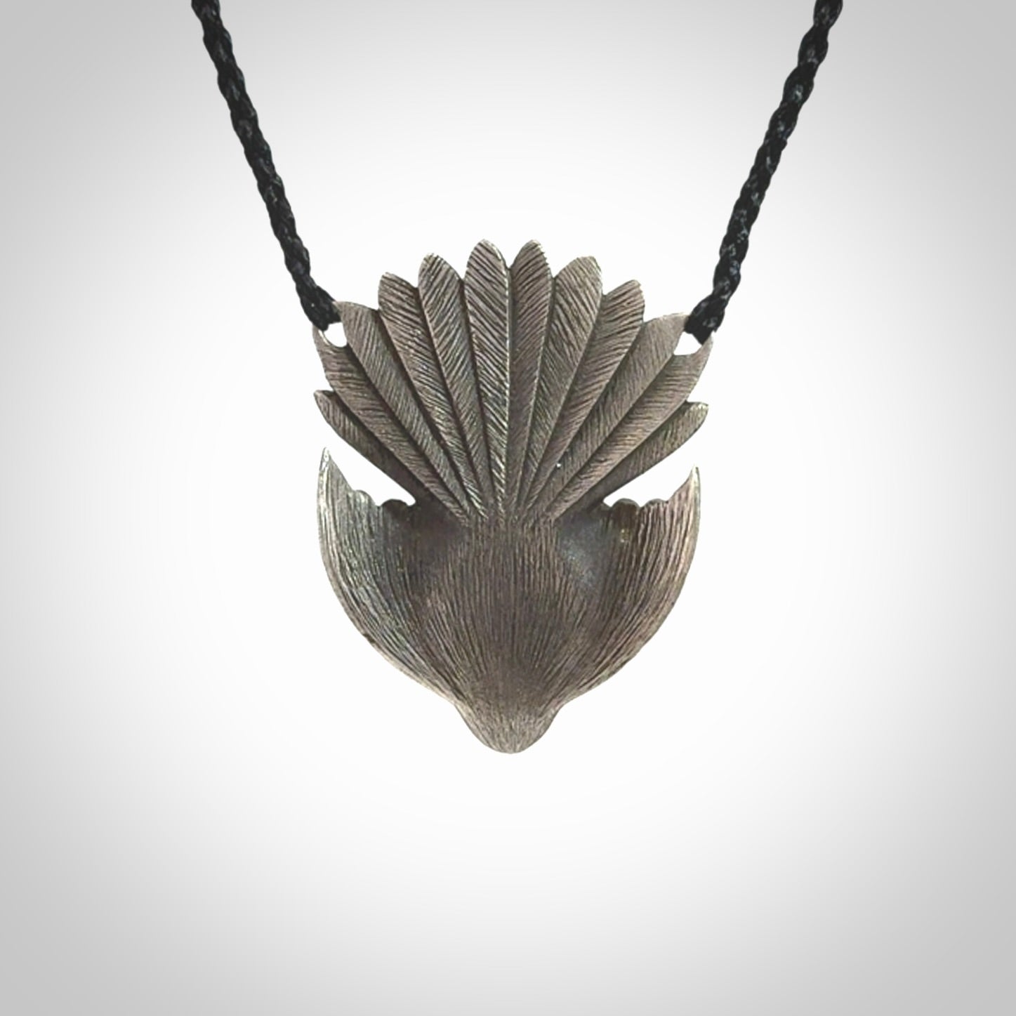 This is a hand carved Sterling Silver Fern fantail pendant with New Zealand Jade insert. This is a medium sized necklace and is provided with an adjustable black cord.