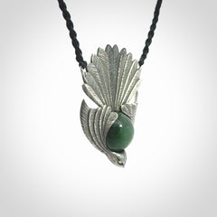 This is a hand carved Sterling Silver Fern fantail pendant with New Zealand Jade insert. This is a medium sized necklace and is provided with an adjustable black cord.
