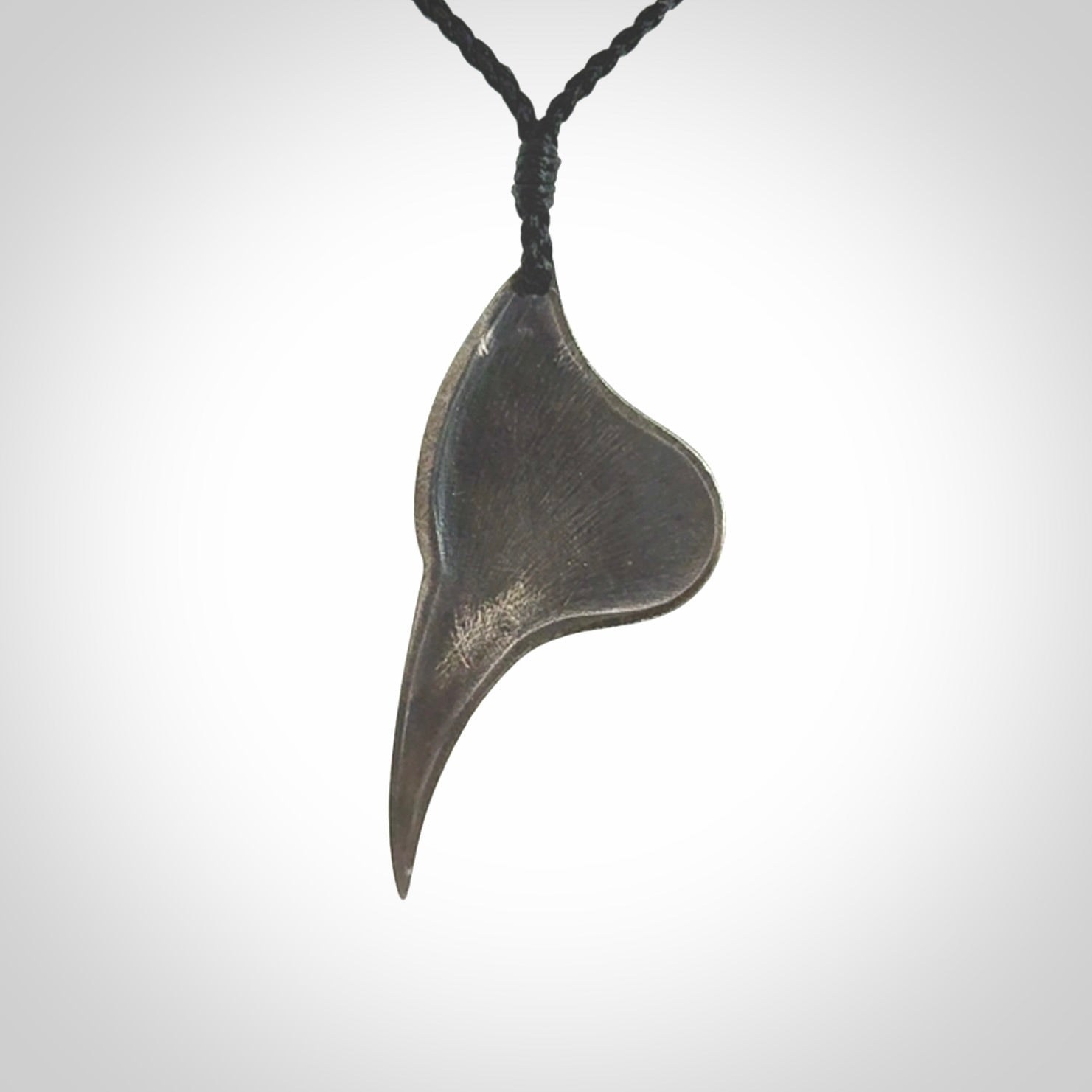 This is a hand carved Sterling Silver Huia bird pendant with Red Cats Eye insert. This is a medium sized necklace and is provided with an adjustable black cord.
