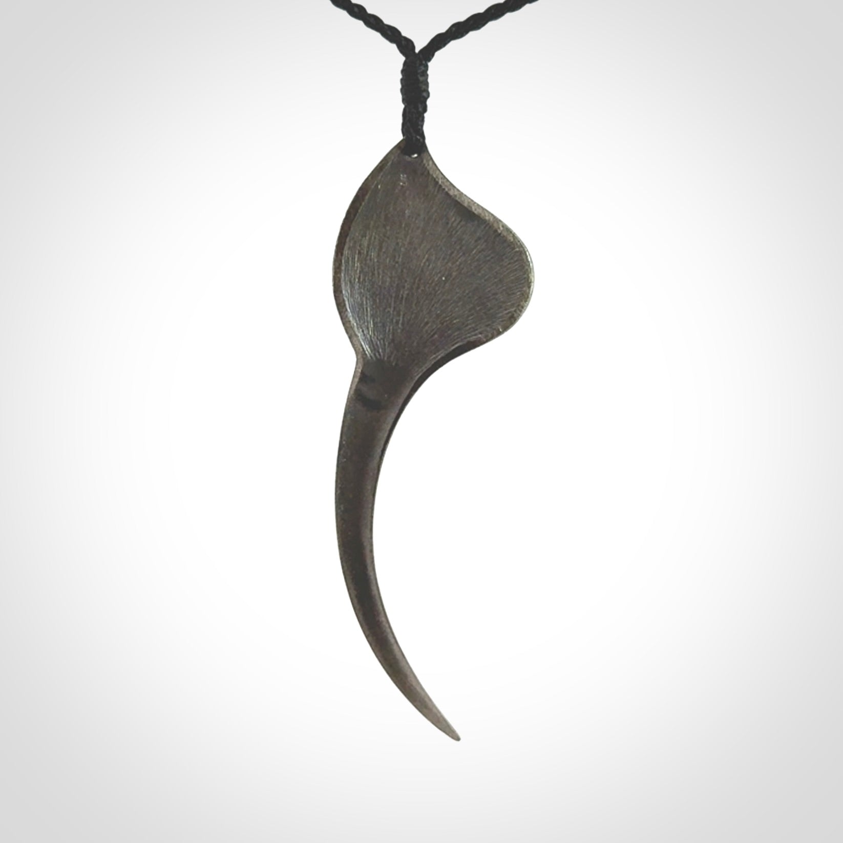 This is a hand carved Sterling Silver Huia bird pendant with Red Cats Eye insert. This is a large sized necklace and is provided with an adjustable black cord.