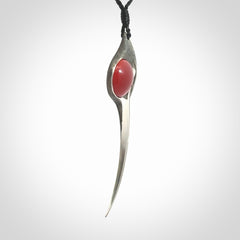 This is a hand carved Sterling Silver Huia bird pendant with Red Cats Eye insert. This is a large sized necklace and is provided with an adjustable black cord.