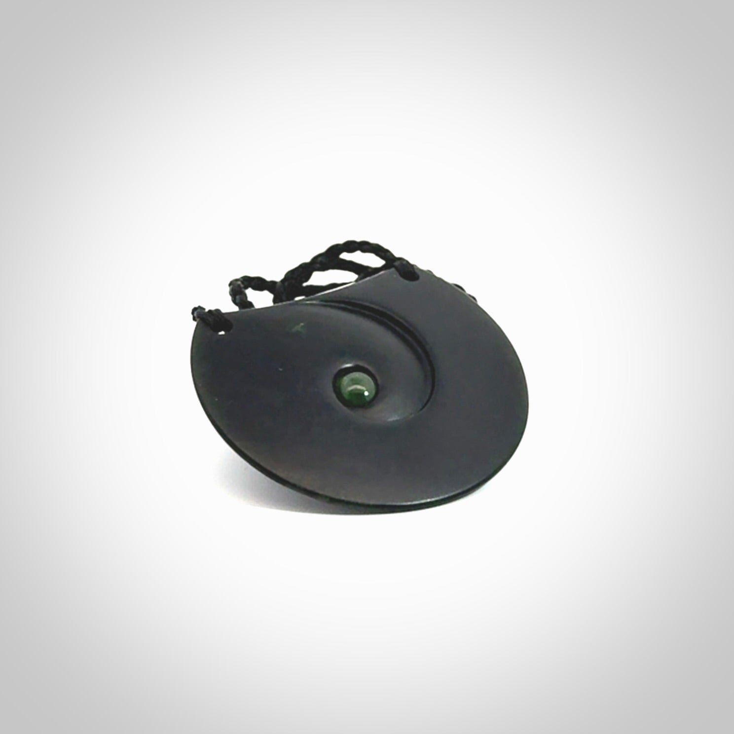 This is a hand carved Black Jade drop pendant with New Zealand Jade insert. This is a medium sized necklace and is provided with an adjustable black cord.