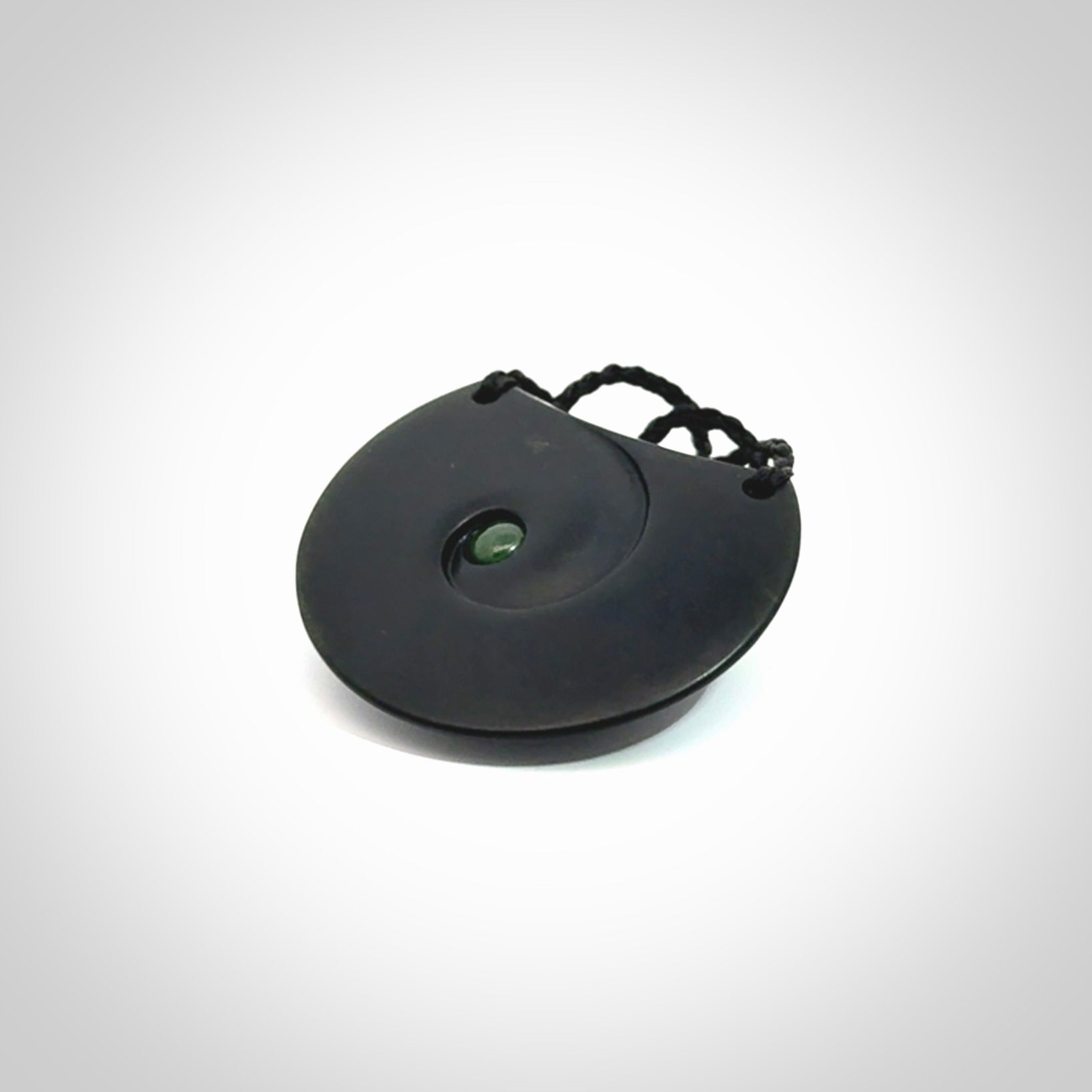 This is a hand carved Black Jade drop pendant with New Zealand Jade insert. This is a medium sized necklace and is provided with an adjustable black cord.
