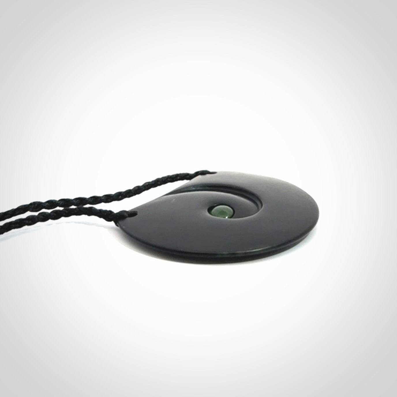 This is a hand carved Black Jade drop pendant with New Zealand Jade insert. This is a medium sized necklace and is provided with an adjustable black cord.