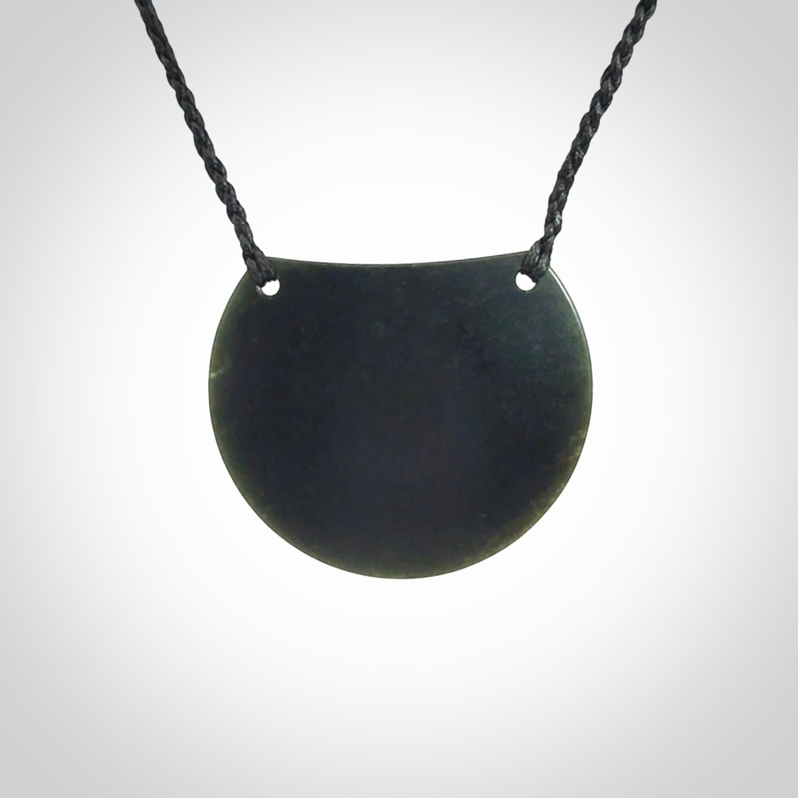 This is a hand carved Black Jade drop pendant with New Zealand Jade insert. This is a medium sized necklace and is provided with an adjustable black cord.