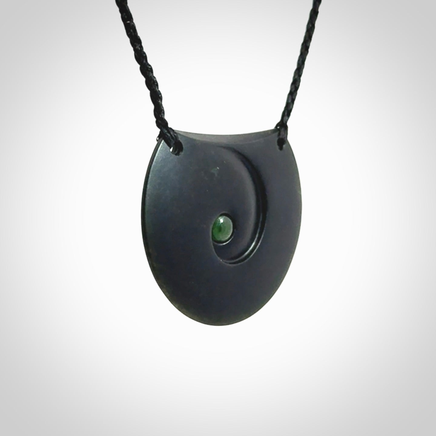 This is a hand carved Black Jade drop pendant with New Zealand Jade insert. This is a medium sized necklace and is provided with an adjustable black cord.