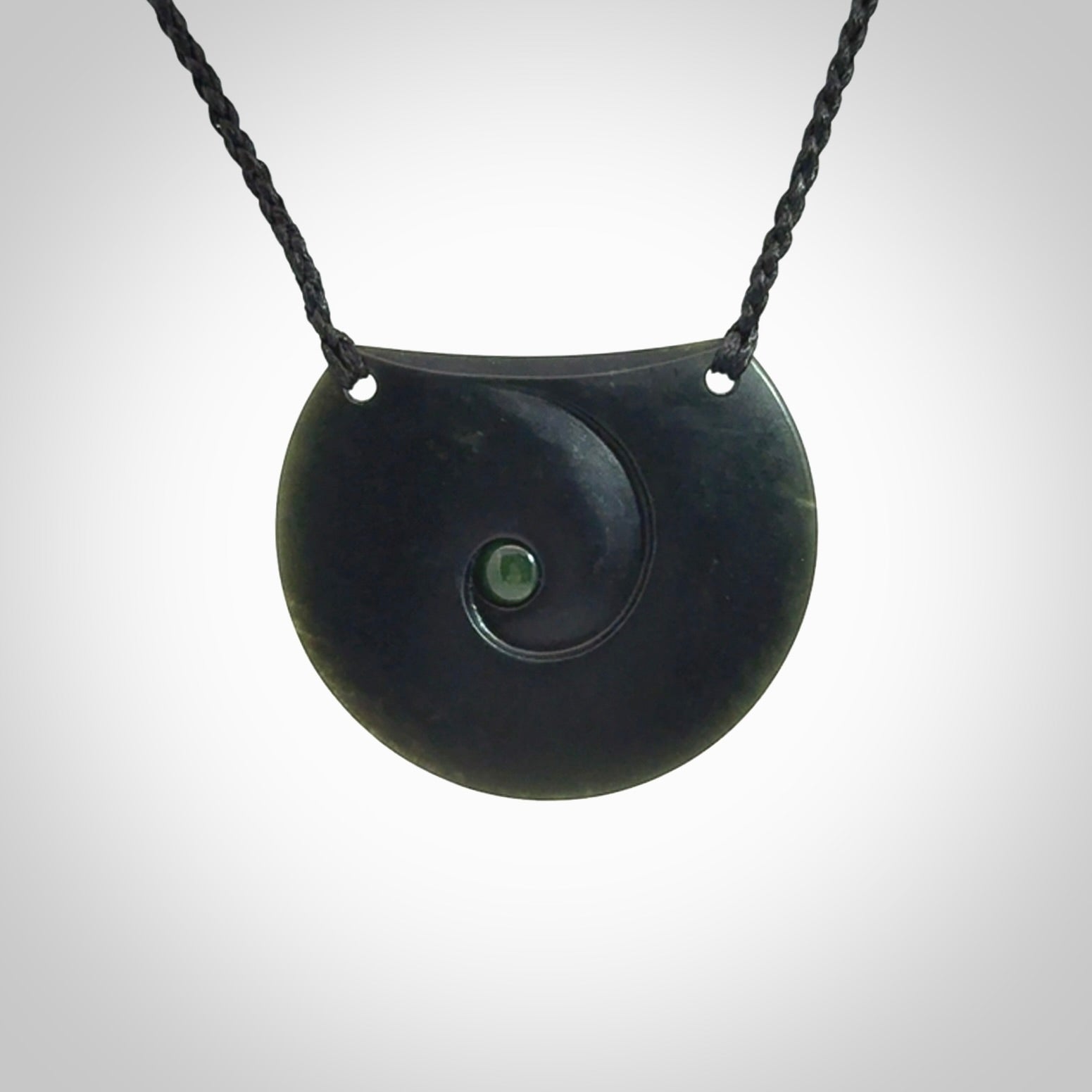 This is a hand carved Black Jade drop pendant with New Zealand Jade insert. This is a medium sized necklace and is provided with an adjustable black cord.