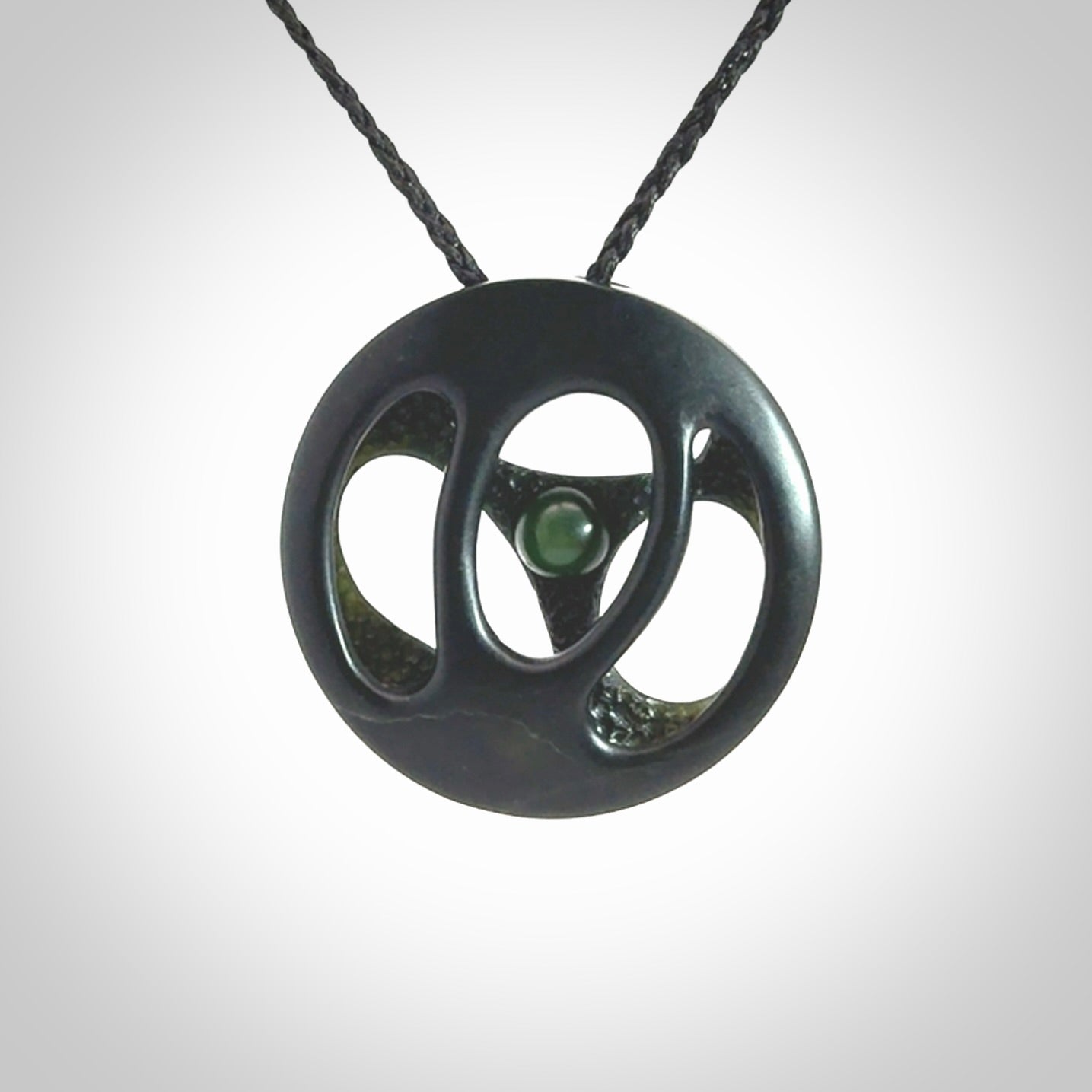 This is a hand carved Black Jade drop pendant with New Zealand Jade insert. This is a medium sized necklace and is provided with an adjustable black cord.