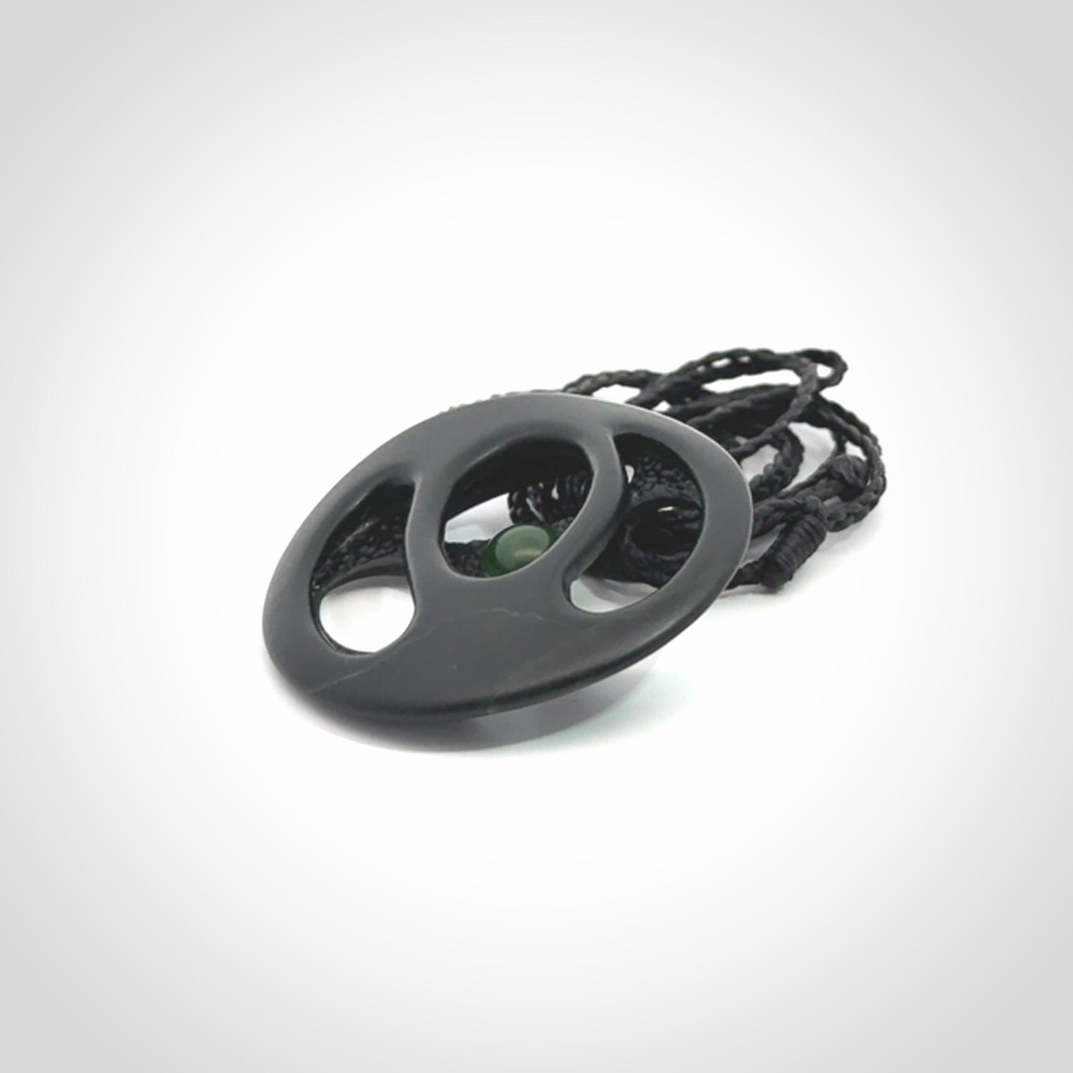This is a hand carved Black Jade drop pendant with New Zealand Jade insert. This is a medium sized necklace and is provided with an adjustable black cord.