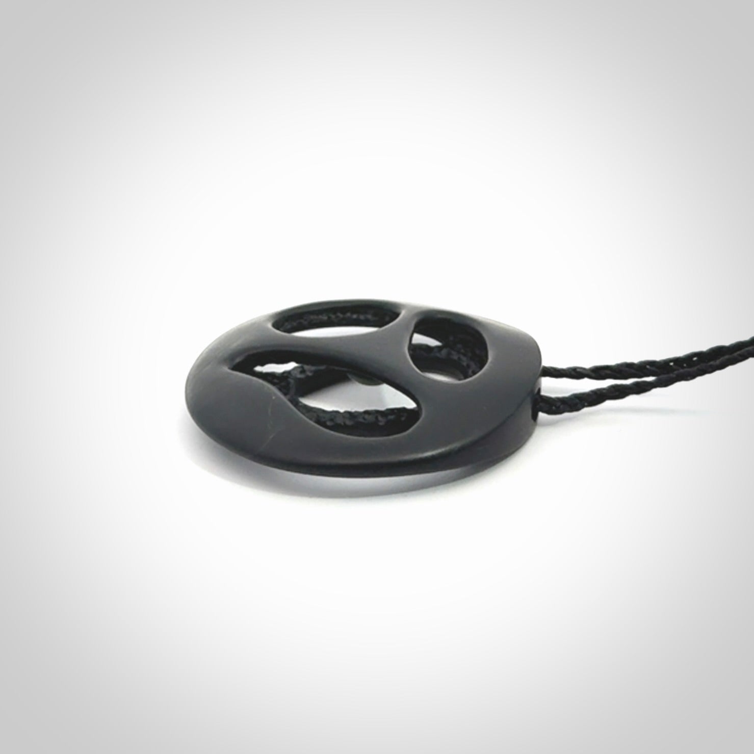 This is a hand carved Black Jade drop pendant with New Zealand Jade insert. This is a medium sized necklace and is provided with an adjustable black cord.