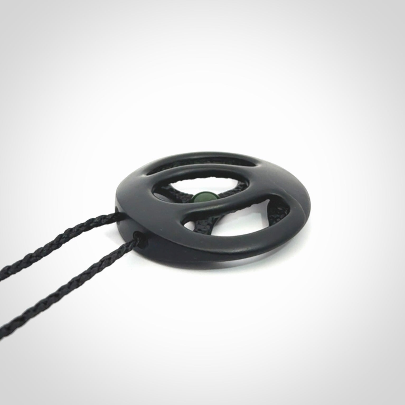 This is a hand carved Black Jade drop pendant with New Zealand Jade insert. This is a medium sized necklace and is provided with an adjustable black cord.