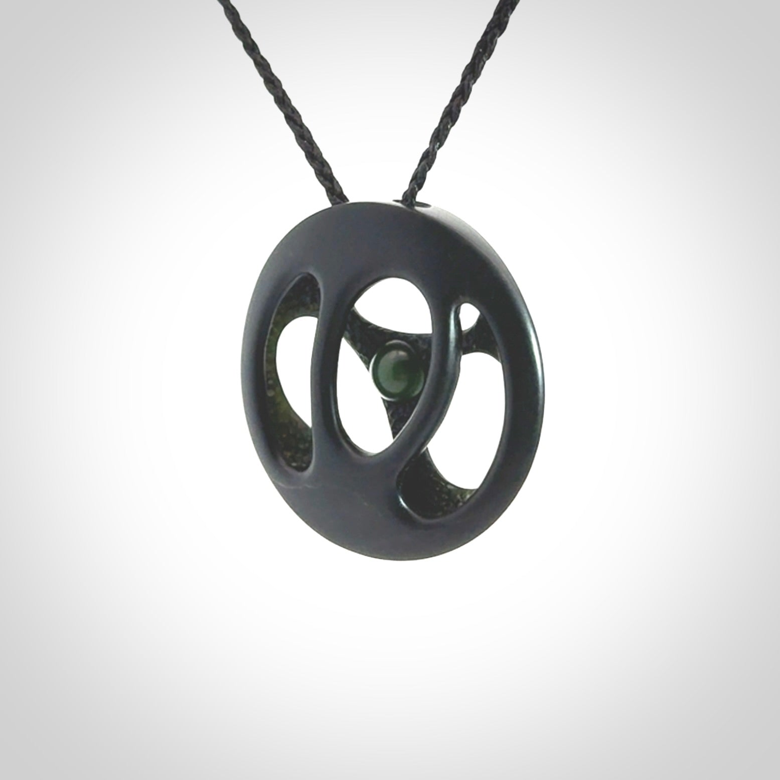 This is a hand carved Black Jade drop pendant with New Zealand Jade insert. This is a medium sized necklace and is provided with an adjustable black cord.
