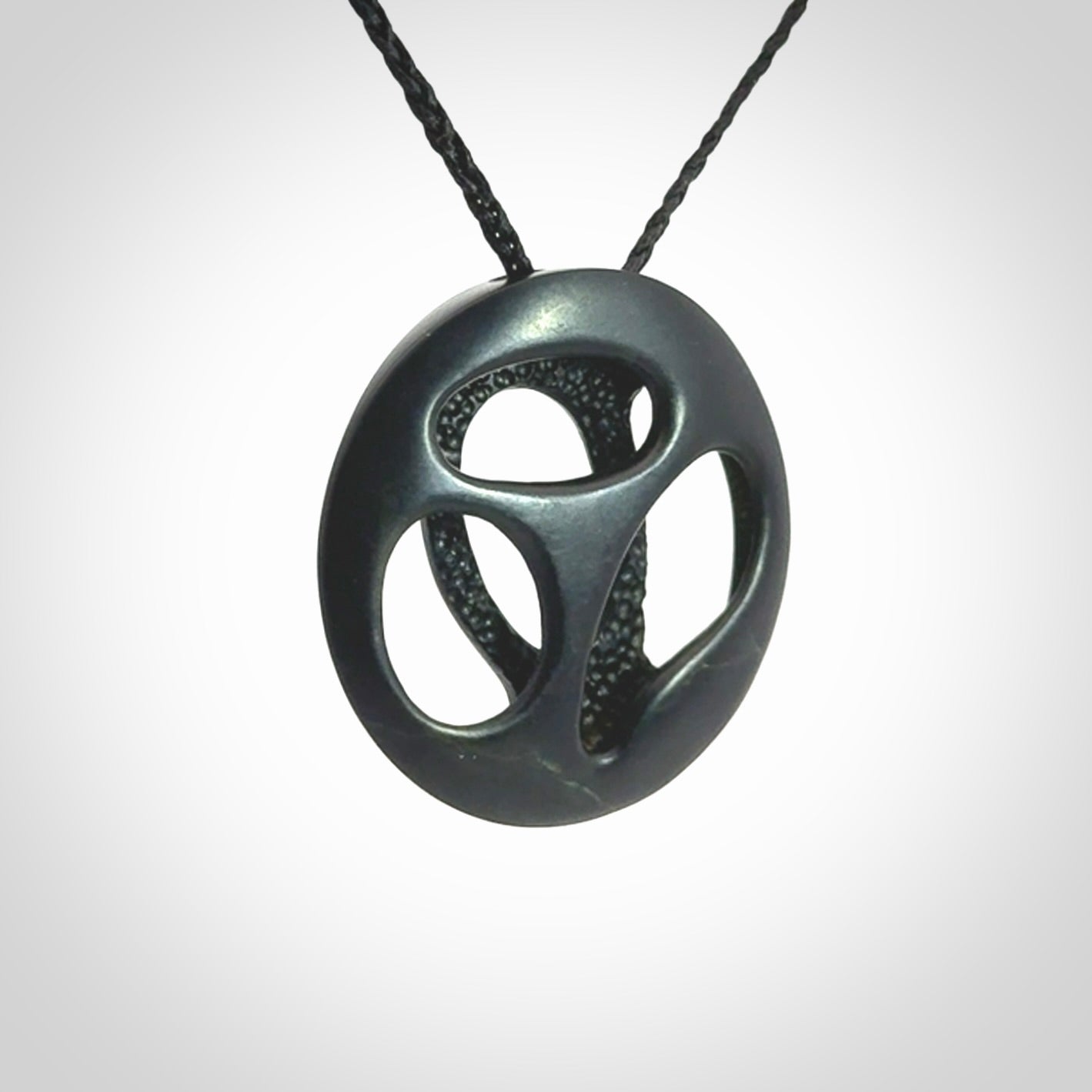 This is a hand carved Black Jade drop pendant with New Zealand Jade insert. This is a medium sized necklace and is provided with an adjustable black cord.