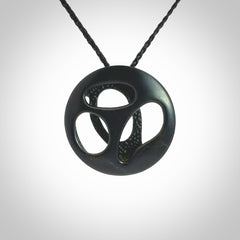 This is a hand carved Black Jade drop pendant with New Zealand Jade insert. This is a medium sized necklace and is provided with an adjustable black cord.