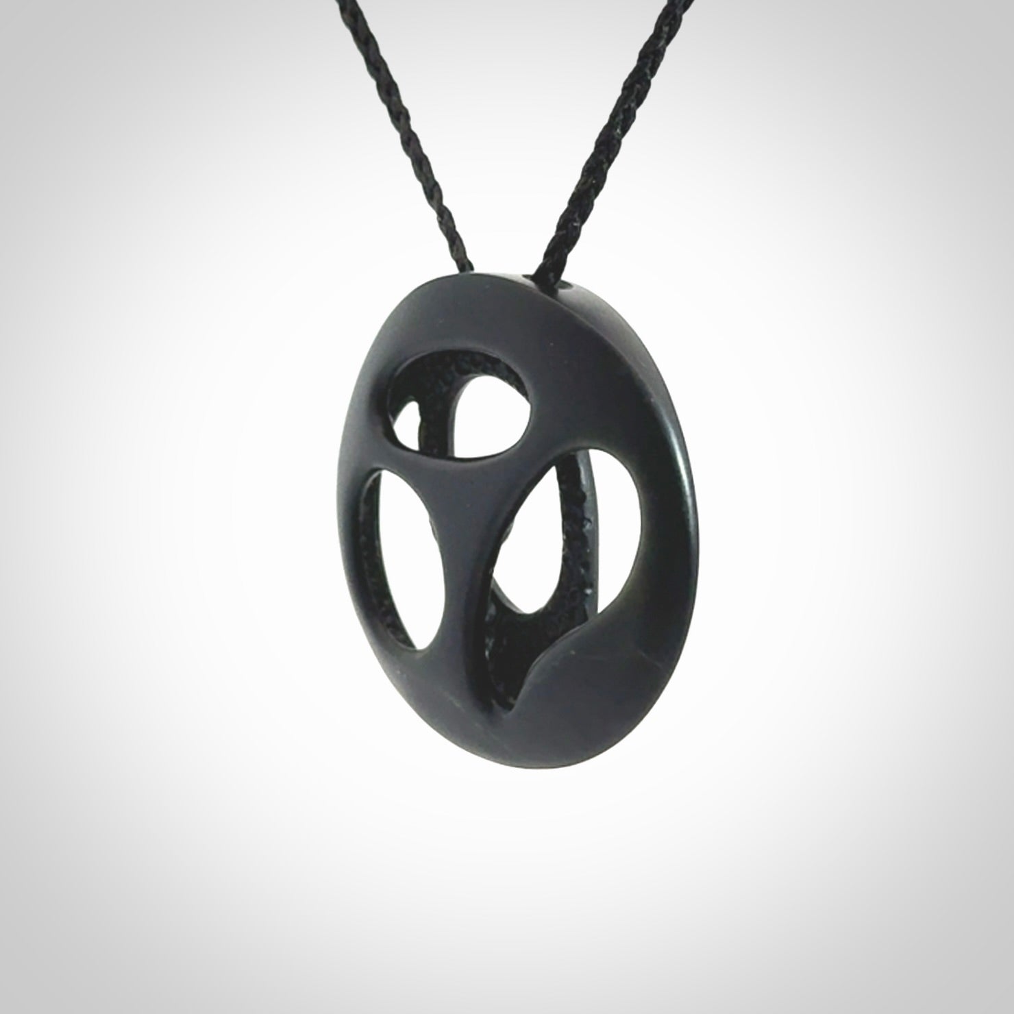 This is a hand carved Black Jade drop pendant with New Zealand Jade insert. This is a medium sized necklace and is provided with an adjustable black cord.