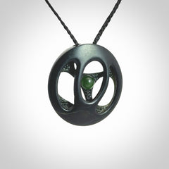 This is a hand carved Black Jade drop pendant with New Zealand Jade insert. This is a medium sized necklace and is provided with an adjustable black cord.
