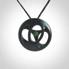 This is a hand carved Black Jade drop pendant with New Zealand Jade insert. This is a medium sized necklace and is provided with an adjustable black cord.