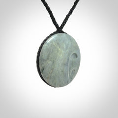 This piece is a contemporary disc pendant hand carved in New Zealand jade.