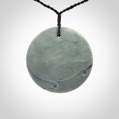This piece is a contemporary disc pendant hand carved in New Zealand jade.