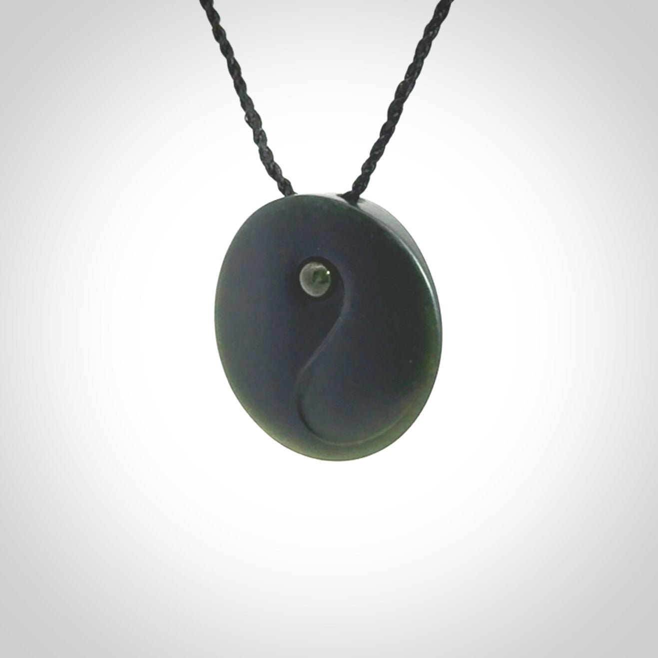 This is a hand carved Black Jade drop pendant with New Zealand Jade insert. This is a smaller sized necklace and is provided with an adjustable black cord.