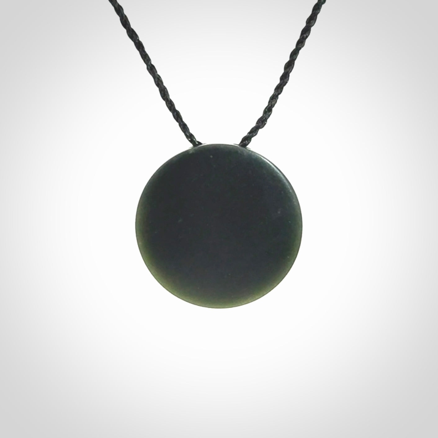 This is a hand carved Black Jade drop pendant with New Zealand Jade insert. This is a smaller sized necklace and is provided with an adjustable black cord.