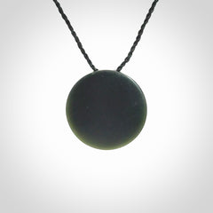 This is a hand carved Black Jade drop pendant with New Zealand Jade insert. This is a smaller sized necklace and is provided with an adjustable black cord.