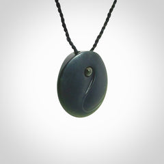 This is a hand carved Black Jade drop pendant with New Zealand Jade insert. This is a smaller sized necklace and is provided with an adjustable black cord.