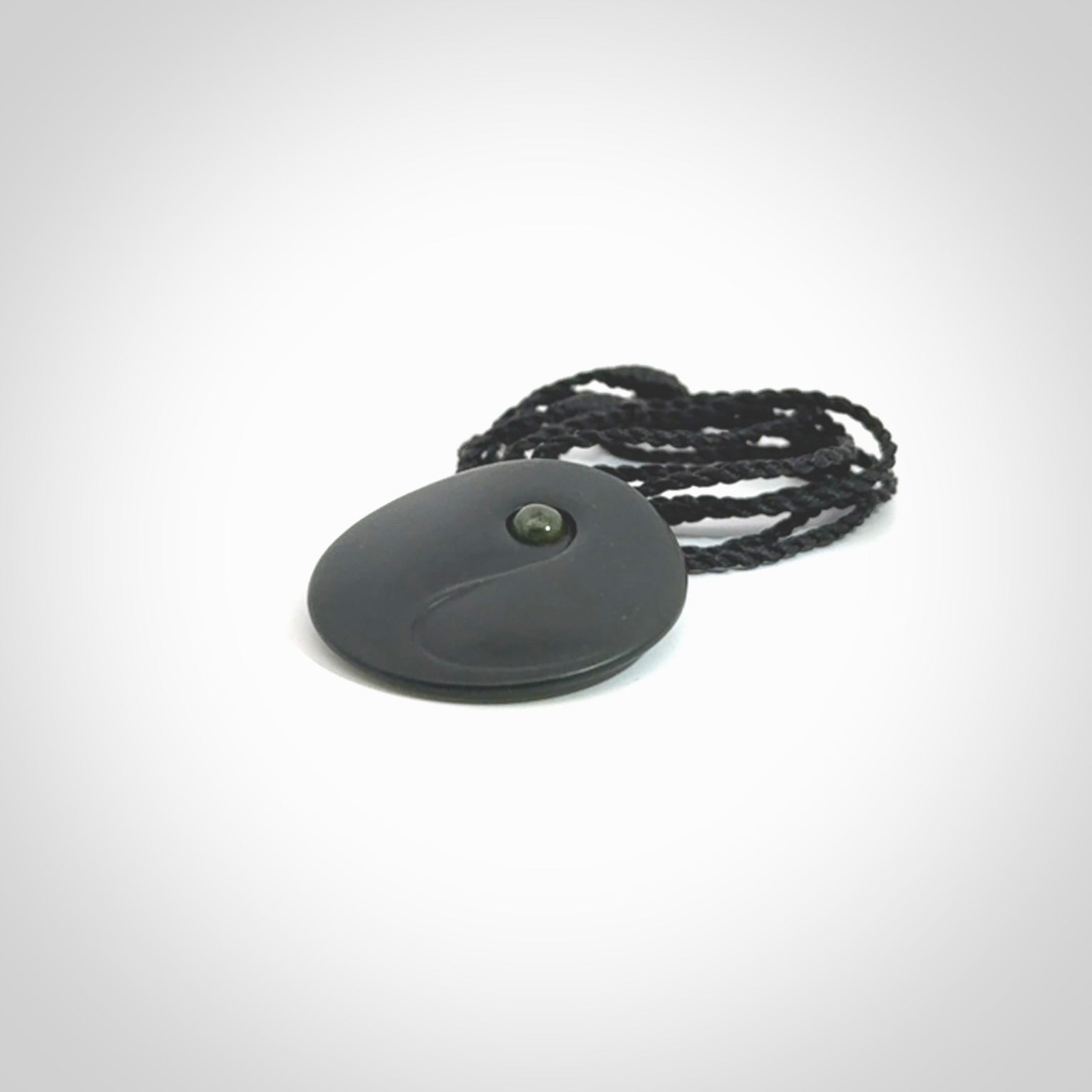 This is a hand carved Black Jade drop pendant with New Zealand Jade insert. This is a smaller sized necklace and is provided with an adjustable black cord.