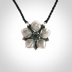 This is a hand carved Sterling Silver Manuka Flower pendant with New Zealand Jade insert. This is a medium sized necklace and is provided with an adjustable black cord.