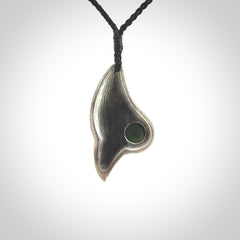 This is a hand carved Sterling Silver Saddleback, Kokako, bird pendant with British Columbian Jade insert. This is a medium sized necklace and is provided with an adjustable black cord.