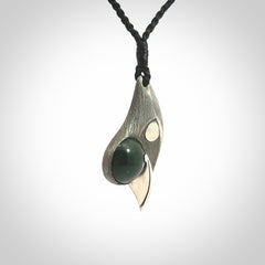 This is a hand carved Sterling Silver Saddleback, Kokako, bird pendant with British Columbian Jade insert. This is a medium sized necklace and is provided with an adjustable black cord.