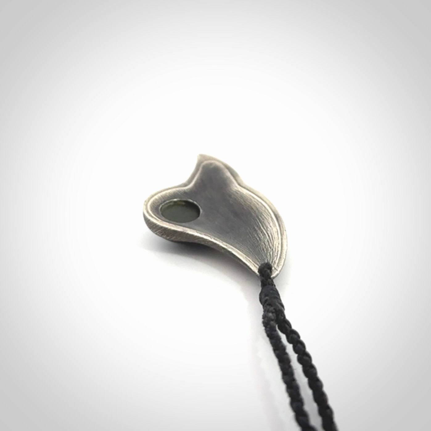 This is a hand carved Sterling Silver Saddleback, Kokako, bird pendant with British Columbian Jade insert. This is a medium sized necklace and is provided with an adjustable black cord.