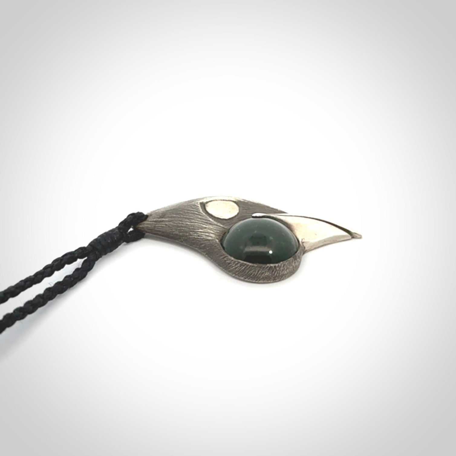 This is a hand carved Sterling Silver Saddleback, Kokako, bird pendant with British Columbian Jade insert. This is a medium sized necklace and is provided with an adjustable black cord.