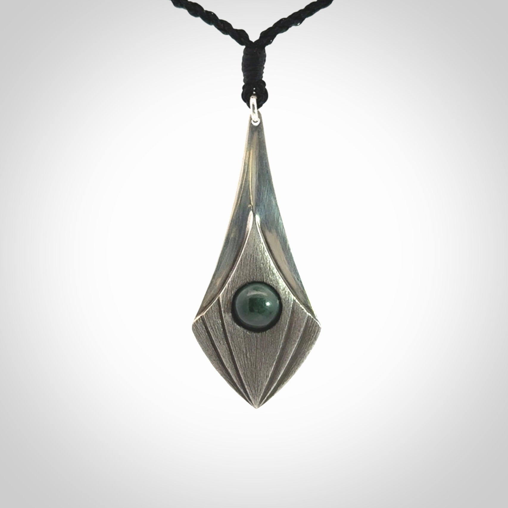 This is a hand carved Sterling Silver lantern drop pendant with New Zealand Jade insert. This is a medium sized necklace and is provided with an adjustable black cord.