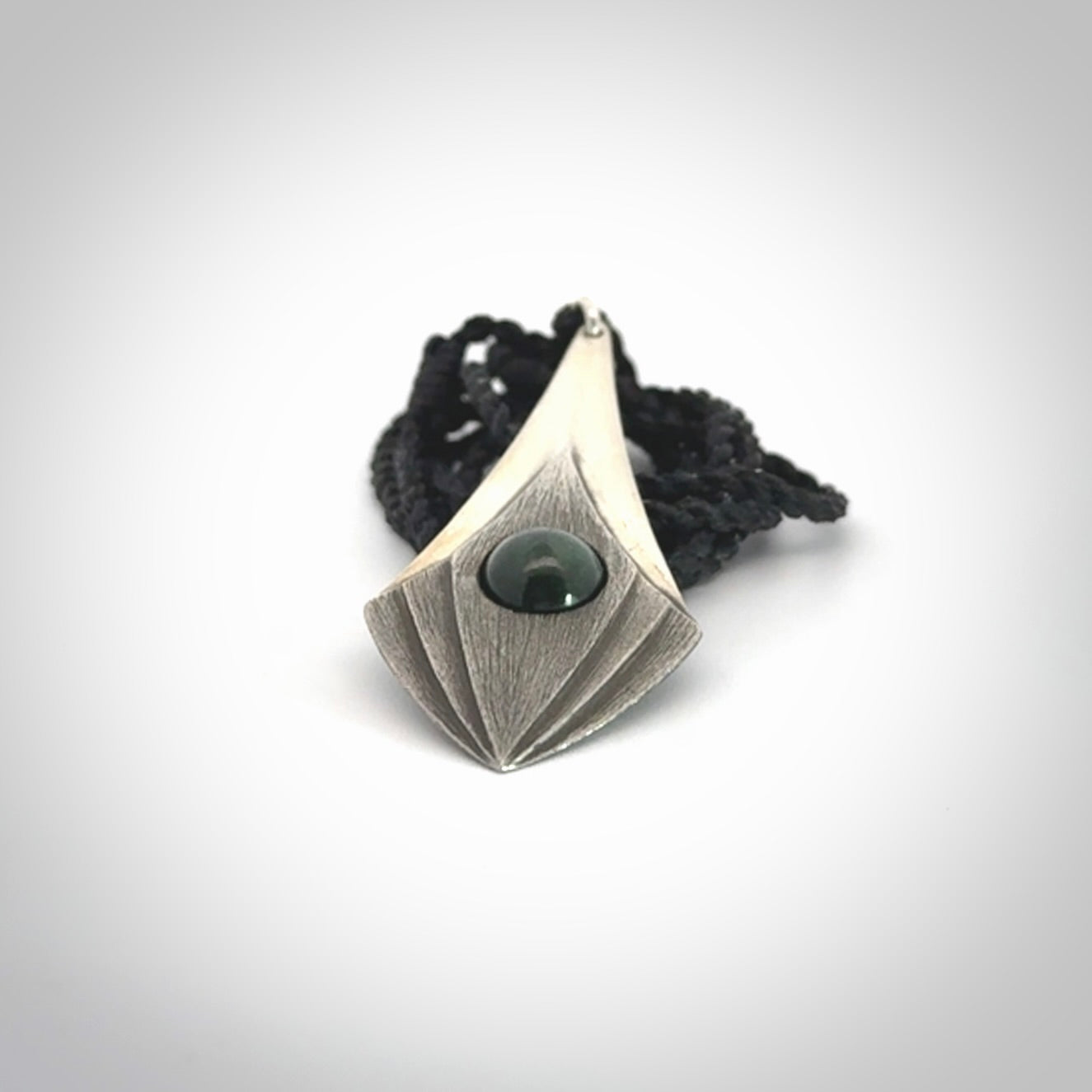 This is a hand carved Sterling Silver lantern drop pendant with New Zealand Jade insert. This is a medium sized necklace and is provided with an adjustable black cord.