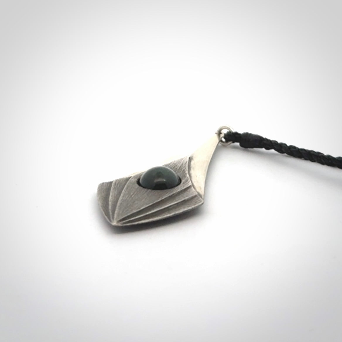 This is a hand carved Sterling Silver lantern drop pendant with New Zealand Jade insert. This is a medium sized necklace and is provided with an adjustable black cord.