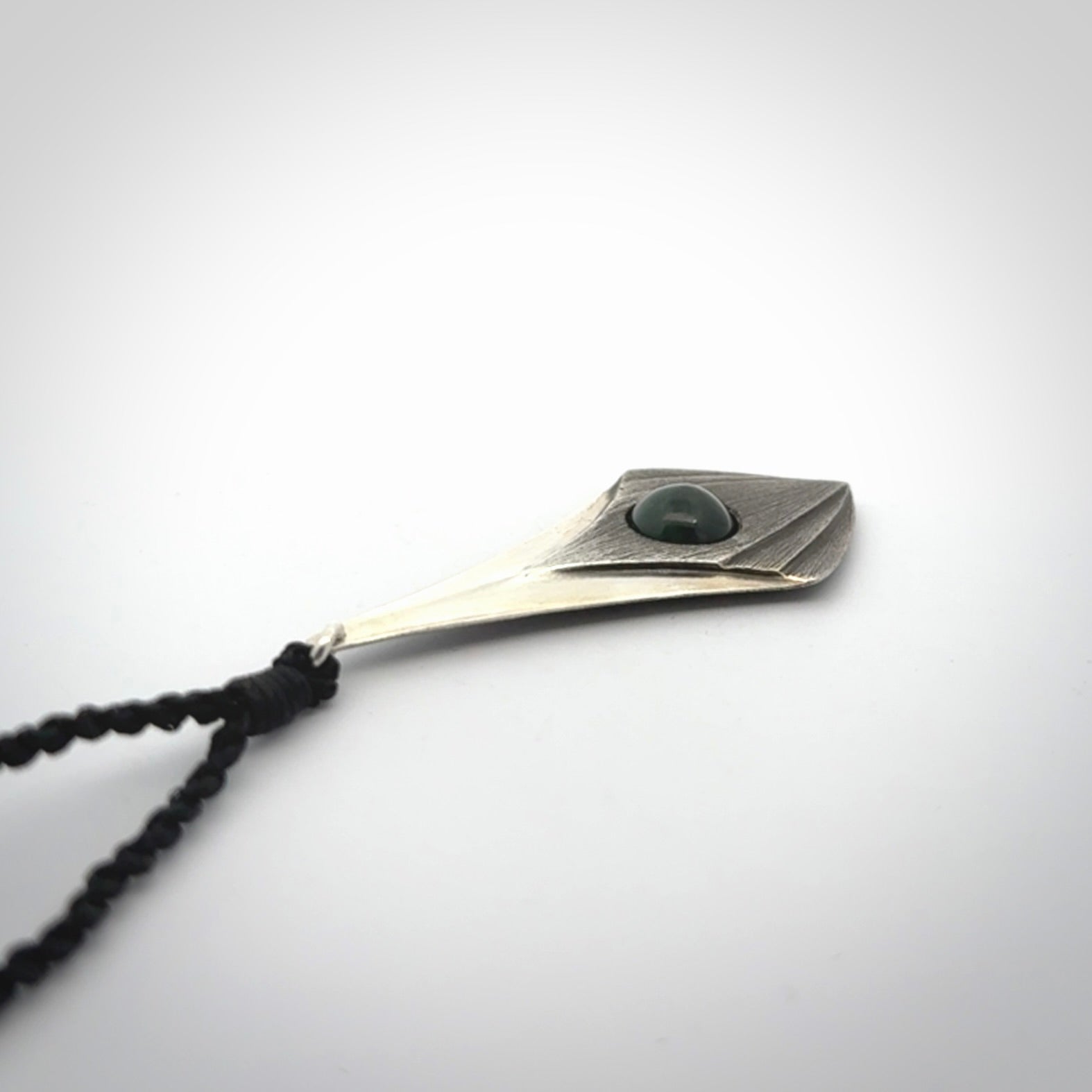 This is a hand carved Sterling Silver lantern drop pendant with New Zealand Jade insert. This is a medium sized necklace and is provided with an adjustable black cord.