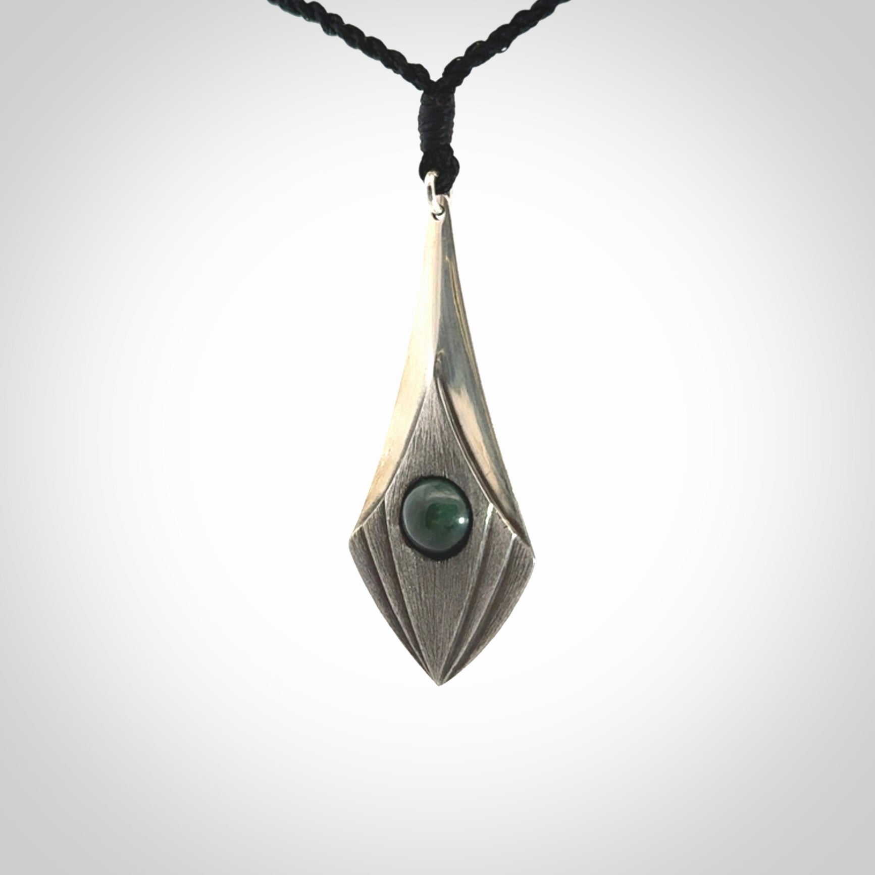 This is a hand carved Sterling Silver lantern drop pendant with New Zealand Jade insert. This is a medium sized necklace and is provided with an adjustable black cord.