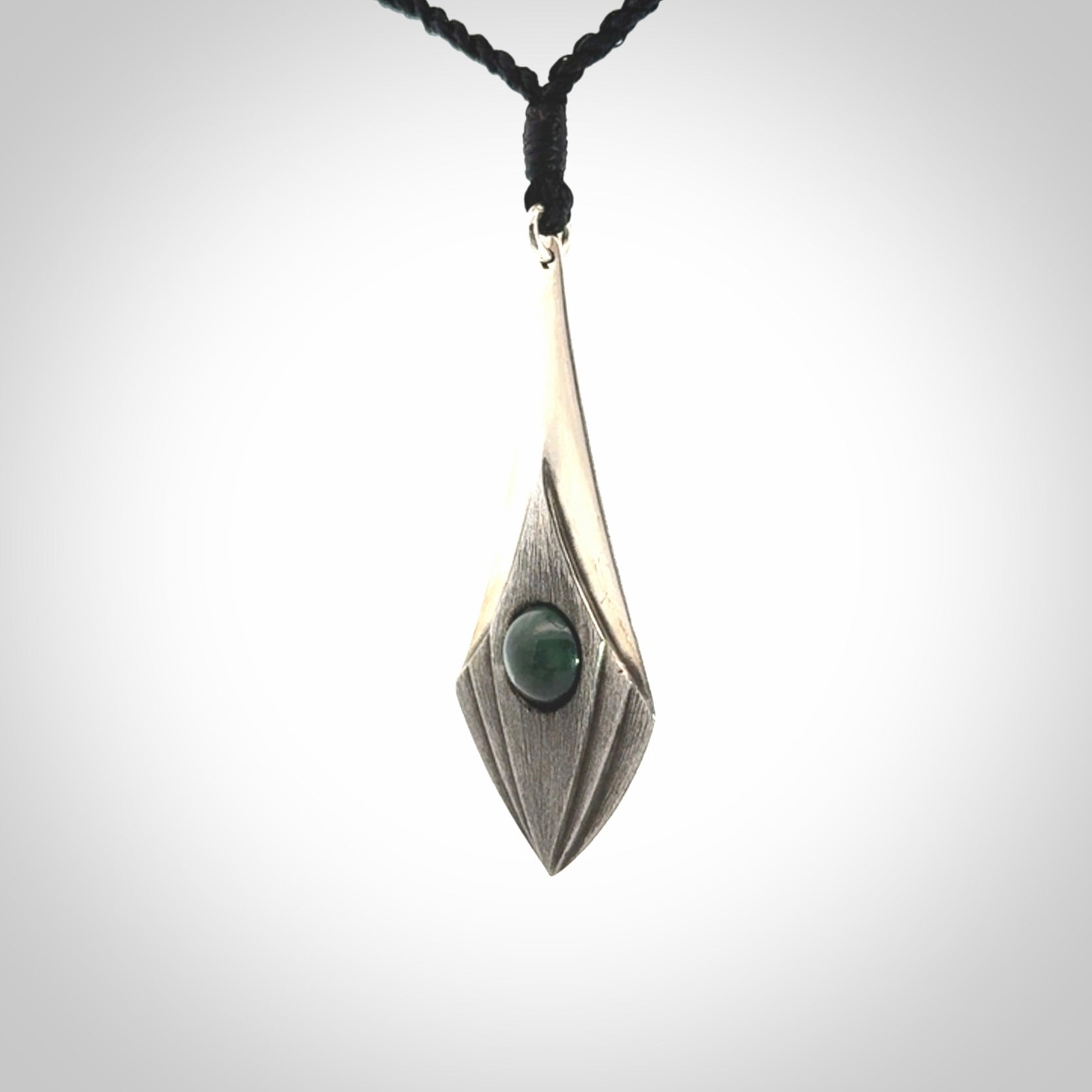 This is a hand carved Sterling Silver lantern drop pendant with New Zealand Jade insert. This is a medium sized necklace and is provided with an adjustable black cord.