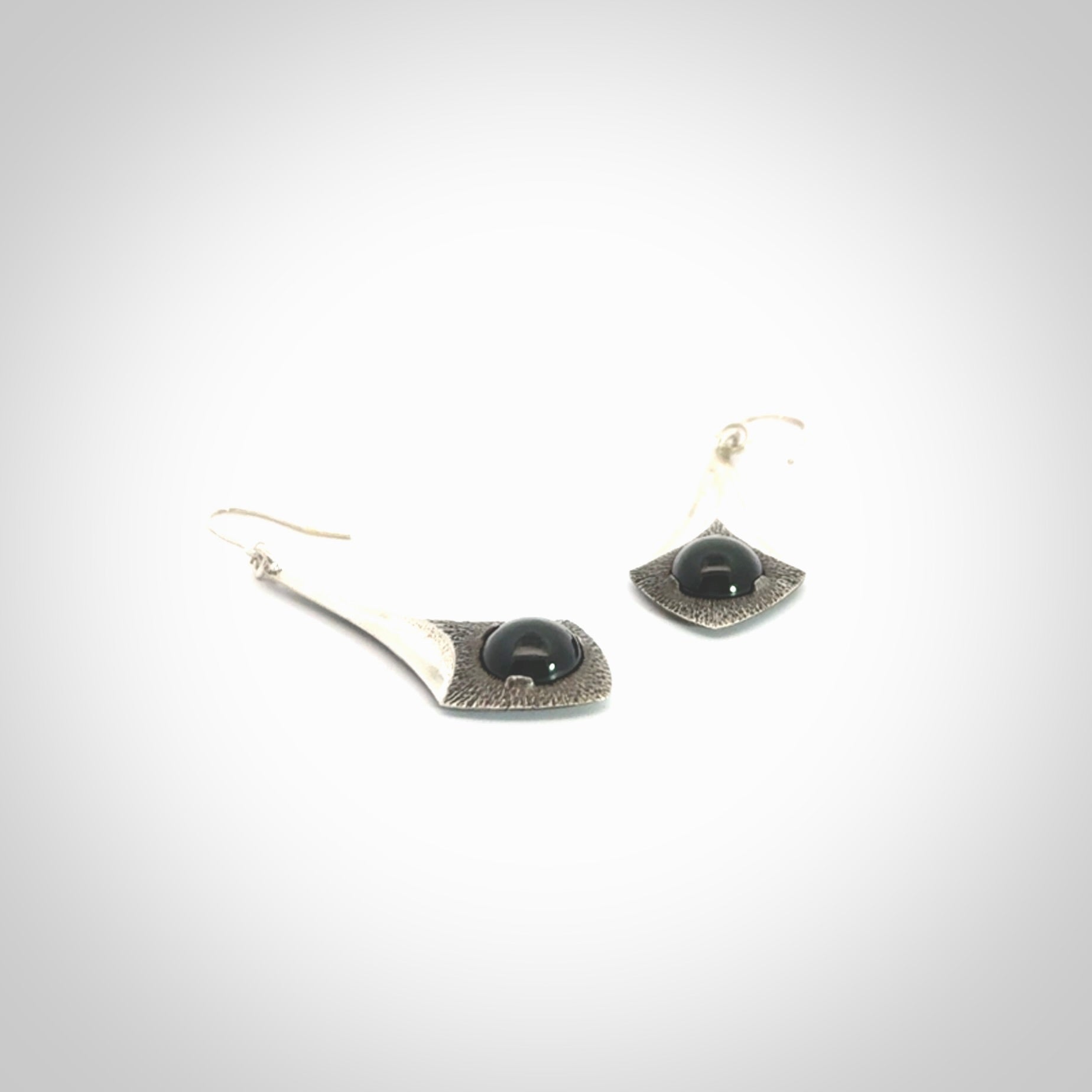 These are hand carved Sterling Silver lantern earrings with New Zealand Jade insert.