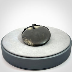 A Hand Carved New Zealand jade disc pendant